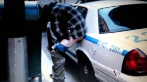 Occupy Wall Street Protester Defecating on a Police Car